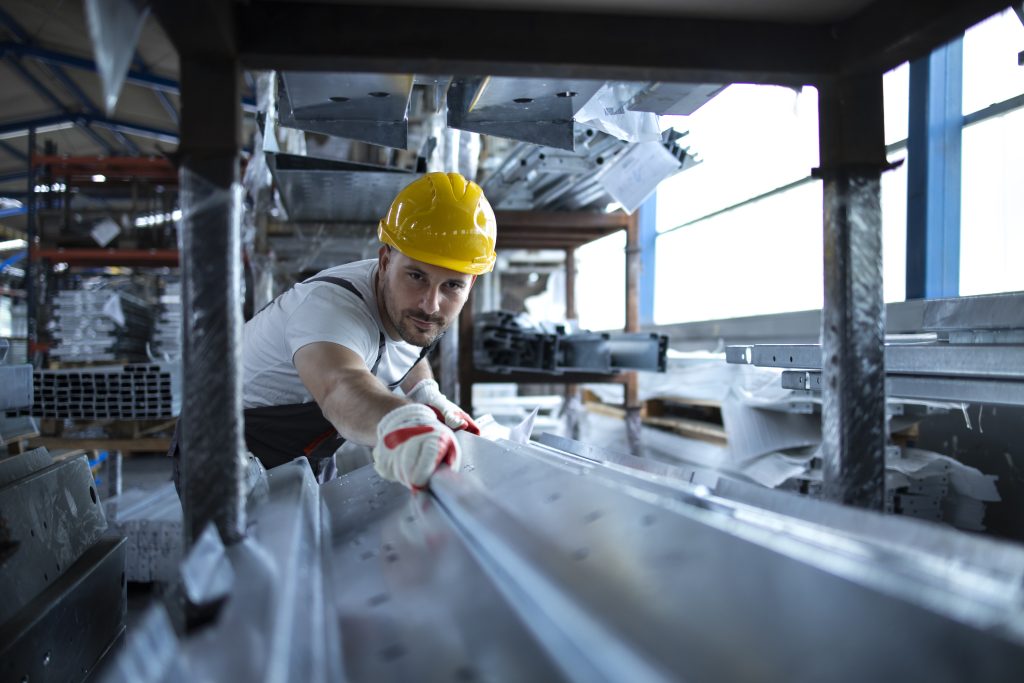 factory worker working warehouse handling metal material production